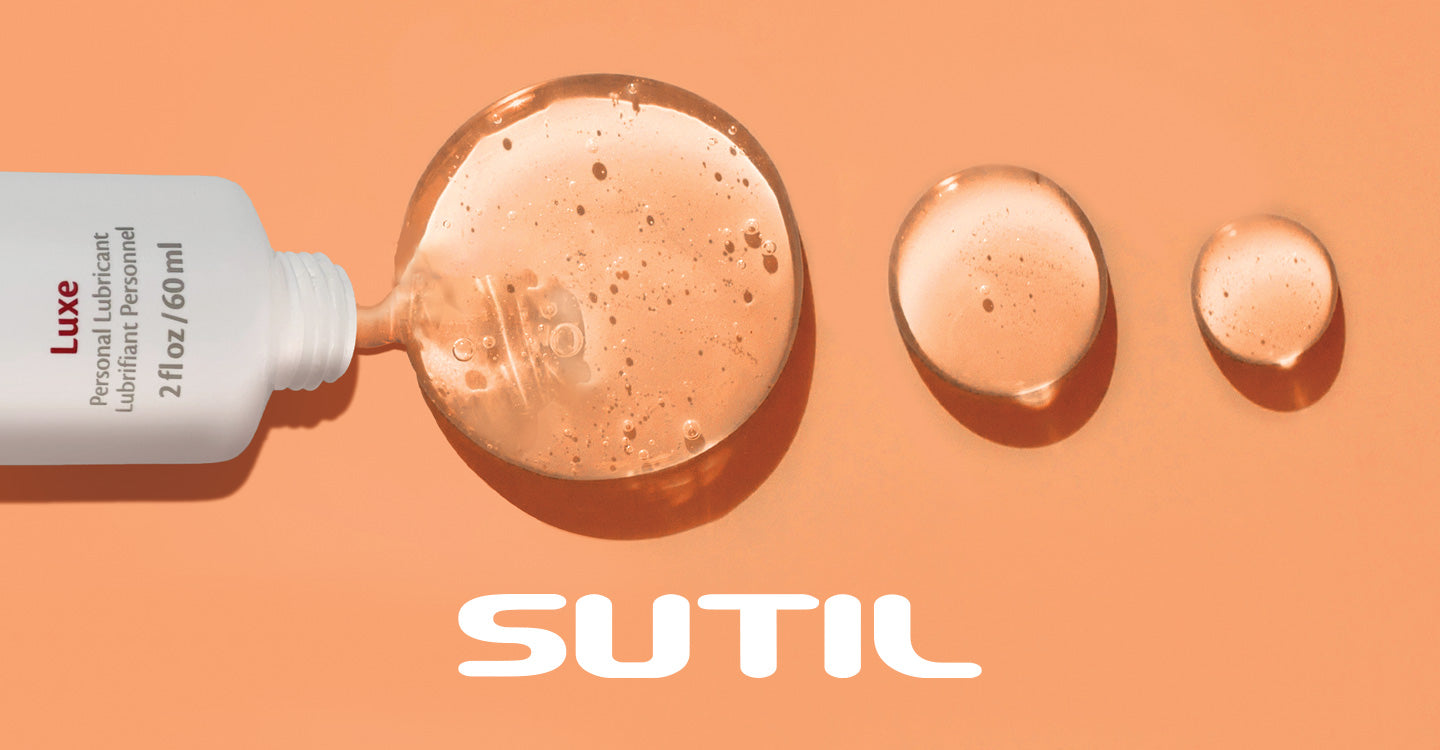 Sutil Luxe Lubricant on a pastel orange background