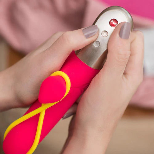 Woman's hand holding the pink Amorino vibrator by Fun Factory