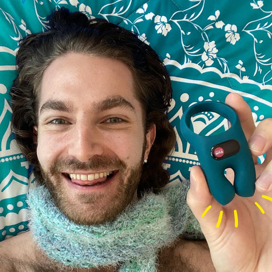 Image of Zachary Zane smiling and holding NOS vibrating c-ring