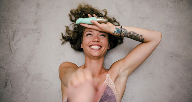 Woman laughing with SUNDAZE in her hand