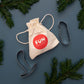 Erotic Cookie Cutter by Fun Factory with a toy bag on a festive background