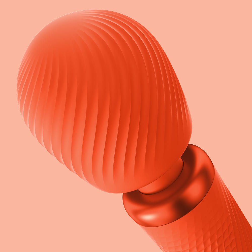 Wand Vibratory by Fun Factory in orange zoomed on the head on an orange background