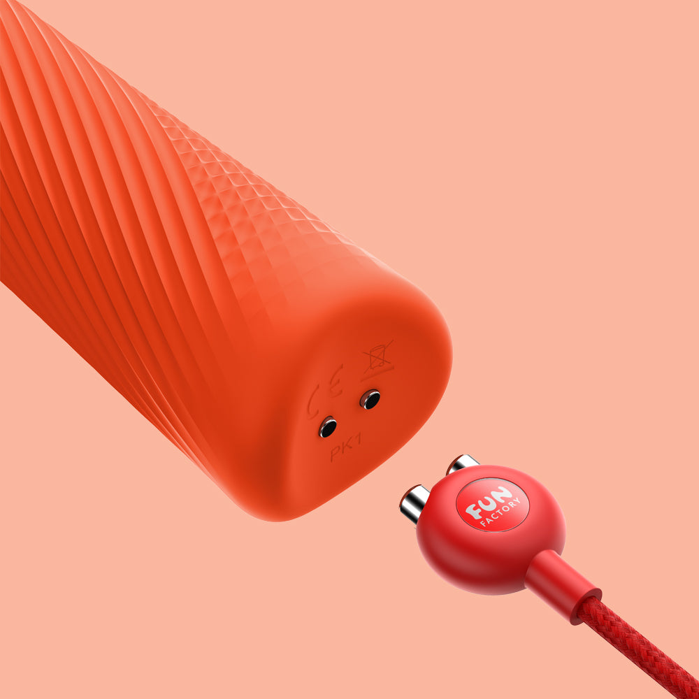Wand Vibratory by Fun Factory in orange showcasing the charger slot on an orange background